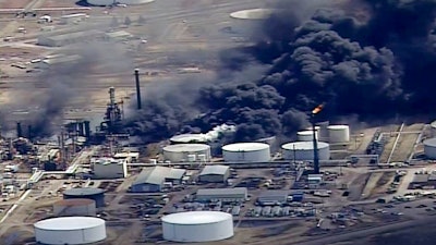 In this April 26, 2018, file image from video, smoke rises from the Husky Energy oil refinery after an explosion and fire at the plant in Superior, Wis. A federal agency reports the explosion at a Wisconsin refinery sent debris into an asphalt storage tank, triggering a massive fire that forced an evacuation last spring. The U.S. Chemical Safety Board released an update Thursday, Aug. 2, 2018 on the explosion and fire at the refinery in late April.