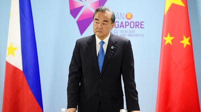 China's Foreign Minister Wang Yi pauses before a bilateral meeting with Philippines' Foreign Affairs Secretary Alan Cayetano on the sidelines of the 51st ASEAN Foreign Ministers Meeting in Singapore, Thursday, Aug. 2, 2018.