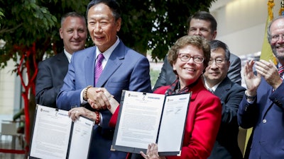 Foxconn CEO Terry Gou, left, and UW-Madison Chancellor Rebecca Blank after signing a Declaration of Collaboration agreement Monday Aug. 27, 2018 at the Wisconsin Institute for Discovery on the UW-Madison campus. Foxconn Technology Group announced Monday, that it will invest $100 million in engineering and innovation research at the University of Wisconsin-Madison, making it one of the largest gifts in the school's history that comes as the Taiwan-based electronics giant builds a factory in southeastern Wisconsin that would be the company's first of its kind in North America.
