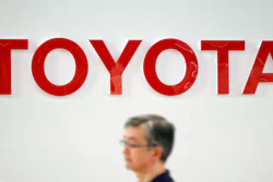 A visitor walks through a Toyota showroom in Tokyo Friday, Aug. 3, 2018. Toyota Motor Corp. has reported its quarterly profit climbed 7.2 percent, helped by strong sales in the U.S. and other overseas markets.