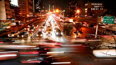 In this Jan. 11, 2018, file photo, cars pass the Queensboro Bridge in New York. The Trump administration is citing safety to justify freezing gas mileage requirements. A draft of a regulation prepared this summer would freeze an Obama-era program to improve fuel efficiency and cut pollution.