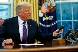President Donald Trump hangs up after talking with Mexican President Enrique Pena Nieto on the phone in the Oval Office of the White House, Monday, Aug. 27, 2018, in Washington.