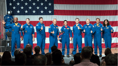 Astronauts, from left to right, Victor Glover, Michael Hopkins, Robert Behnken, Douglas Hurley, Nicole Mann, Christopher Ferguson, Eric Boe, Josh Cassada and Sunita Williams give a thumbs up to the crowd after NASA announced them as astronauts assigned to crew the first flight tests and missions of the Boeing CST-100 Starliner and SpaceX Crew Dragon, Friday, Aug. 3, 2018, in Houston. The astronauts will ride the first commercial capsules into orbit next year and return human launches to the U.S.