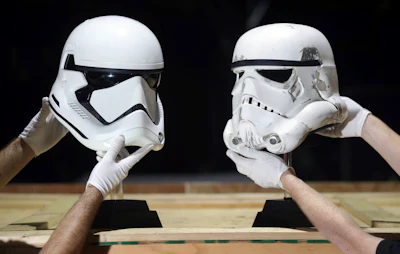 Stormtrooper helmets from Star Wars: The Last Jedi (left) (estimate $39,000-$65,000) and Star Wars: A New Hope (right) (estimate $52,000-$78,000) on display in the Prop Store head office.