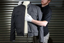 Prop Store employee James Chapman adjusts Han Solo's jacket, as worn by Harrison Ford in Star Wars.