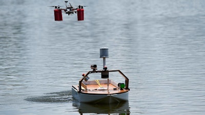 An unmanned autonomous vehicle (UAV) lifts off from Florida Atlantic University's autonomous robotic boat during the finals of the 2018 International RoboBoat Competition held at Reed Canal Park in South Daytona, Fla.