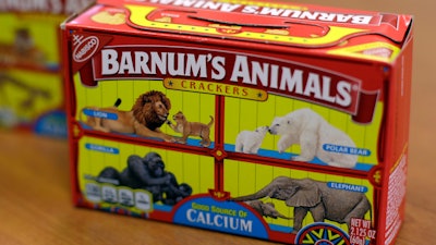 This Monday, Aug. 20, 2018, photo shows boxes of Nabisco's Barnum's Animals crackers in Chicago. After more than a century behind bars, the beasts on boxes of animal crackers are roaming free. The new boxes retain their familiar red and yellow coloring and prominent 'Barnum's Animals' lettering. But instead of showing the animals in cages, implying that they're traveling in boxcars for the circus, the new boxes feature a zebra, elephant, lion, giraffe and gorilla wandering side-by-side in a grassland.