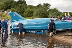The restored Bluebird K7, which crashed killing pilot Donald Campbell in 1967, takes to the water for the first time in more than 50 years off the Isle of Bute on the west coast of Scotland, Saturday Aug. 4, 2018. The famed jet boat Bluebird has returned to the water for the first time since a 1967 crash that killed pilot Donald Campbell during a world speed-record attempt. Watched by Campbell's daughter Gina Campbell, the restored Bluebird was lowered Saturday into Loch Fad on Scotland's Isle of Bute, where it will undergo low-speed tests.