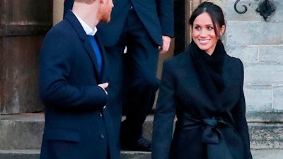 In this Thursday, Jan.18, 2018 file photo, Britain's Prince Harry and his fiancee Meghan Markle leave after a visit to Cardiff Castle in Cardiff, Wales. When Meghan wore jeans from the Hiut Denim Company, there was worldwide publicity about a firm in Wales which started to re-employ workers displaced when the local factory closed, helping small companies like Hiut buck the globalization trend.
