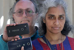 In this July 25, 2018 photo, Kalyanaraman Shankari, right, and her husband Thomas Raffill hold their phones while posing for photos in Mountain View, Calif.