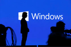 In this May 11, 2017, file photo Alex Kipman, a technical fellow at Microsoft, stands on stage after speaking at the Microsoft Build 2017 developers conference in Seattle. Microsoft stands virtually alone among tech companies with its aggressive approach that uses U.S. courts to fight computer fraud and seize hacked websites back from malicious perpetrators. But in the process, the company is taking on a role that might look more like the job of government than a corporation.