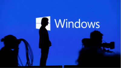 In this May 11, 2017, file photo Alex Kipman, a technical fellow at Microsoft, stands on stage after speaking at the Microsoft Build 2017 developers conference in Seattle. Microsoft stands virtually alone among tech companies with its aggressive approach that uses U.S. courts to fight computer fraud and seize hacked websites back from malicious perpetrators. But in the process, the company is taking on a role that might look more like the job of government than a corporation.