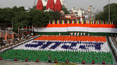 Indian children sit in formation to spell out the Hindi word 'Bharat', which is the name of the country as they listen to Indian Prime Minister Narendra Modi address the nation on the country's Independence Day from the ramparts of the historical Red Fort in New Delhi, India, Wednesday, Aug. 15, 2018.