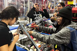 This March 3, 2018 photo provided by Heather Anderson shows, from left, Navajo Mountain High School students Nahida Smith, Myra King and Breana Bitsinne compete in a Utah regional robotics competition in West Valley City, Utah. The team from a remote town in southern Utah is now headed to an international robotics competition Aug. 14 in Mexico City, Mexico. They were invited to compete in the First Global Challenge, which will draw teams from 190 countries to create robots capable of feeding power plants and building environmentally efficient transmission networks.