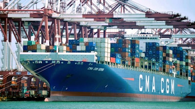 In this July 6, 2018, file photo, a container ship is docked at a port in Qingdao, in eastern China's Shandong Province.