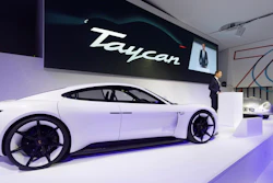 In this Aug. 6, 2018, photo provided by Porsche AG, Oliver Blume, CEO of Porsche AG, speaks next to the Taycan during the ceremonial opening of “70 Years Porsche Sportscar” at the Porsche Museum in Stuttgart, Germany. While Tesla grapples with internal issues like production delays, a sometimes-erratic CEO and a recent about-face on whether to go private, its rivals are moving aggressively into the luxury electric vehicle space. Porsche is taking on Tesla's Model S high performance luxury car with the Taycan, expected to reach the market in late 2019.