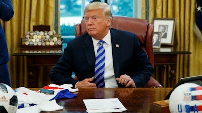 President Donald Trump listens to a question during a meeting with FIFA president Gianni Infantino and United States Soccer Federation president Carlos Cordeiro in the Oval Office of the White House, Tuesday, Aug. 28, 2018, in Washington.