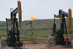 In this June 12, 2014 file photo, natural gas is burned off near pumps in Watford City, N.D. As Trump rolls back some Obama-era rules on climate-changing methane pollution, Colorado officials say their regulations have reduced oil field leaks. A report released Thursday, Aug. 23, 2018, shows required state inspections helped find and repair 73,000 methane leaks over three years.