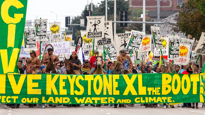 In this Aug. 6, 2017, file photo, demonstrators against the Keystone XL pipeline march in Lincoln, Neb. Civil liberties advocates have sued the U.S government alleging law enforcement agencies are maneuvering to crack down on anticipated protests over the Keystone XL oil pipeline. Attorneys for the American Civil Liberties Union want the court to order the release of all records pertaining to cooperation between federal, state and local law enforcement and private security companies. The suit cites prior efforts to disband protesters opposed to a separate project, the Dakota Access Pipeline.