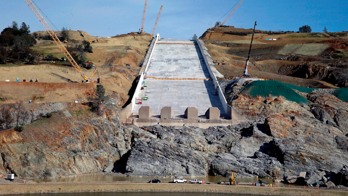 In this Nov. 30, 2017, file photo, work continues on the Oroville Dam spillway in Oroville, Calif. Officials say the cost of dealing with last year's near-disaster at the nation's tallest dam in California have climbed to more than $1 billion. The state Department of Water Resources said Wednesday, Sept. 5, 2018, construction costs and related expenses are driving the increase at Oroville Dam.