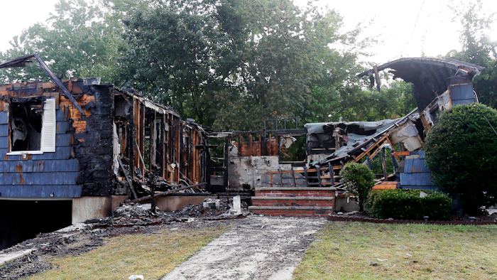 The house owned by Lawrence Police Officer Ivan Soto sits nearly burned to the ground on. It was one of multiple houses that went up in flames on Thursday afternoon after gas explosions and fires triggered by a problem with a gas line that feeds homes in several communities north of Boston. After rushing home to check on his family and warn his neighbors to evacuate, Soto went back on patrol while his house was burning down.