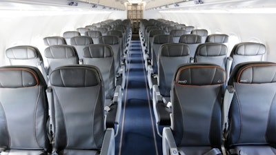This Thursday, March 16, 2017, file photo shows the interior of a commercial airliner at John F. Kennedy International Airport in New York. On Wednesday, Sept. 26, 2018, the House voted to direct the federal government to set a minimum size for airline seats, bar passengers from being kicked off overbooked planes, and consider whether to restrict animals on planes.