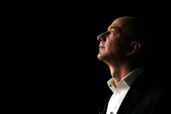 In this Sept. 6, 2012, file photo, Jeff Bezos, CEO and founder of Amazon, is illuminated by a display screen at the introduction of the new Amazon Kindle Fire HD and Kindle Paperwhite in Santa Monica, Calif. On Tuesday, Sept. 4, 2018, Amazon became the second publicly traded company to be worth $1 trillion, hot on the heels of Apple. The company's blowout success made Bezos, No. 1 on Forbes' billionaires list this year.