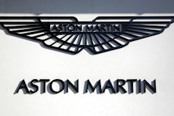 In this file photo dated Wednesday, Feb. 24, 2016, an Aston Martin sign is seen outside a dealership on Park Lane in London. Aston Martin Lagonda, the maker of James Bond's favorite sports car, said Thursday Sept. 20, 2018, that it plans to raise as much as 1.27 billion pounds (dlrs 1.67 billion US) when it sells shares to investors for the first time.
