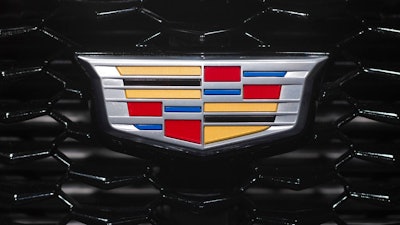In this March 27, 2018, file photo the Cadillac emblem is shown on the from grill of its XT4 at the New York Auto Show. General Motors is moving its Cadillac brand headquarters from New York City back to Michigan, to bring workers closer to designers.