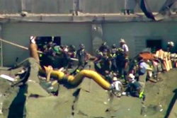 This aerial frame grab from video by WFLD-TV in Chicago shows rescue personnel at the scene where several people were reported trapped inside a Chicago water reclamation plant after a fire and possible explosion caused part of the building's roof to collapse Thursday, Aug. 30, 2018.