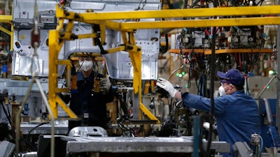 Workers assemble the BAIC Jeep chassis frames at the Chinese automaker BAIC ORU assembly plant in Beijing, Wednesday, Aug. 29, 2018. Their tariff war with the U.S. grabs headlines, but China faces bigger economic challenges than U.S. President Donald Trump. Communist leaders who are trying to nurture more sustainable growth in the world’s No. 2 economy clamped down on bank lending to rein in surging debt.