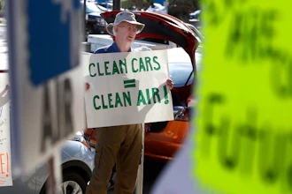 Paul Gipe protests before the first of three public hearings on the Trump administration's proposal to roll back car-mileage standards in a region with some of the nation's worst air pollution Monday, Sept. 24, 2018 in Fresno, Calif. The day-long session by the U.S. Environmental Protection Agency and National Highway Traffic Safety Administration is a means to gather public comment concerning the mileage plan, which would freeze U.S. mileage standards at levels mandated by the Obama administration for 2020, instead of letting them rise to 36 miles per gallon by 2025.