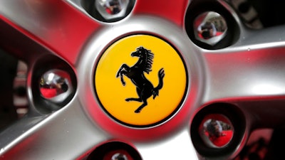 This Monday, Oct. 9, 2017 file photo shows a Ferrari logo on a car outside the New York Stock Exchange in New York. Ferrari is blazing its future under new leadership on limited edition cars based on iconic models of the past, unveiling on Tuesday Sept. 18, 2018, the first in the Icona special series billed as the most-powerful road car in the company’s history.