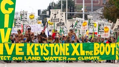 In this Aug. 6, 2017, file photo, demonstrators against the Keystone XL pipeline march in Lincoln, Neb. Civil liberties advocates have sued the U.S government alleging law enforcement agencies are maneuvering to crack down on anticipated protests over the Keystone XL oil pipeline. Attorneys for the American Civil Liberties Union want the court to order the release of all records pertaining to cooperation between federal, state and local law enforcement and private security companies. The suit cites prior efforts to disband protesters opposed to a separate project, the Dakota Access Pipeline.