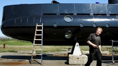 This April 30, 2008 file photo shows a submarine and its owner Peter Madsen. Danish submarine inventor Peter Madsen, who was found guilty of the torture, sexual assault, murder and dismemberment of a Swedish reporter, appeared before an appeals court Wednesday Sept. 5, 2018, to fight against his life sentence.