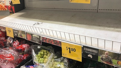 Empty shelves, normally stocked with strawberry punnets, are seen at a Coles Supermarket in Brisbane. Public fears about sewing needles concealed inside strawberries on supermarket shelves have spread across Australia and New Zealand as growers turn to metal detectors and the Australian government launches an investigation to restore confidence in the popular fruit.