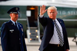 President Donald Trump waves to members of the media after arriving on Air Force One, Friday, Aug. 31, 2018 at Andrews Air Force Base in Md. Watching is Air Force Col. Samuel Chesnut.