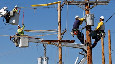 In this May 9, 2018, file photo students and apprentices work in various stages of training to be a line worker at the Duquesne Light Co. training center in Pittsburgh. They are taking part in a partnership training program with the Community College of Allegheny County. On Friday, Sept. 7, the Labor Department reports on job openings and labor turnover for August.