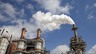 In this March 29, 2018, photo, steam is released out of the Valero Refinery in Houston. More than a year after Hurricane Harvey slammed into the Texas coast, state environmental authorities have only just begun enforcement actions against a handful of companies deemed responsible for some of the most massive air and water pollution incidents reported during and immediately after the storm.