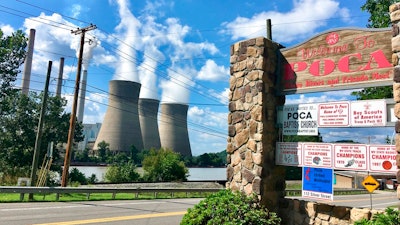 In this Aug. 23, 2018 photo, American Electric Power’s John Amos coal-fired plant in Winfield, W.Va., is seen from the town of Poca across the Kanawha River. President Donald Trump picked West Virginia where he announced rolling back pollution rules for coal-fired power plants. But he didn’t mention that the northern two-thirds of West Virginia, with the neighboring part of Pennsylvania, would be hit hardest.