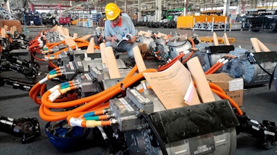 In this Aug. 29, 2018, photo, a man works in an auto parts factory in Liaocheng in eastern China's Shandong province. The Trump administration announced Monday, Sept. 17, 2018, that it will impose tariffs on $200 billion more in Chinese goods starting next week, escalating a trade war between the world's two biggest economies and potentially raising prices on goods ranging from handbags to bicycle tires.