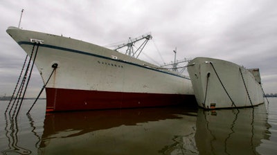 In this Feb. 9, 2005, file photo, the Savannah rests beside the Sturgis barge, right, which are both anchored near Newport News, Va. The Sturgis is a 440-foot-long World War II Liberty ship that the Army converted into a floating nuclear power plant in 1966. Crews in Galveston, Texas have completed work on the former ship that was converted to a barge-mounted nuclear reactor but has now been cleared of irradiated waste and will be scrapped. The former USS Sturgis will be towed to Brownsville later this month.