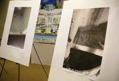 Photographs showing a cracked steel beam found in the Salesforce Transit Center are displayed during a news conference Wednesday, Sept. 26, 2018, in San Francisco. A second beam in San Francisco's celebrated new $2 billion transit terminal shows signs of cracking, an official said Wednesday, a day after a crack in a nearby support beam shut down the building that opened just last month. The first crack found by workers installing roof tiles Tuesday spans a beam holding up a park over the three-block-long facility and runs over a downtown street, Salesforce Transit Center Zabaneh said.