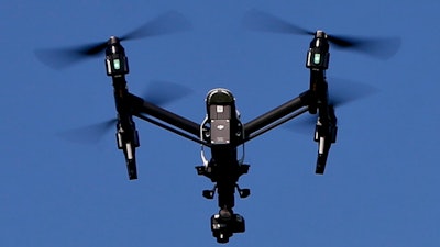 In this July 11, 2018 file photo, a drone equipped with a thermal camera flies over the plants at the Pennsylvania Department of Natural Resources' Jennings Environmental Education Center on Wednesday, July 11, 2018 in Slippery Rock, Pa. An aviation bill Congress is rushing to approve contains a little-noticed section that would give authorities the power to track, intercept and destroy drones they consider a security threat, without needing a judge's approval. Supporters say law enforcement needs this power to protect Americans from terrorists who are learning how to use drones as deadly weapons.