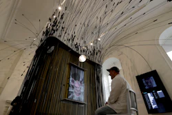 The United States installation 'Face Values', by designers Zachary Lieberman, sat demonstrating in the chair, and R. Luke DuBois, not pictured, which explores the role of facial detection technology in society is displayed during a media preview for the London Design Biennale at Somerset House in London, Monday, Sept. 3, 2018. The event runs from September 4 to 23.