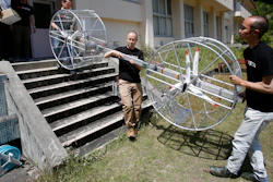 In this June 3, 2017, file photo, members of Cartivator carry propellers of the test model flying car in Toyota, central Japan. The Japanese government has started a “flying car” project, bringing together more than a dozen companies, including All Nippon Airways, electronics company NEC, Toyota-backed startup Cartivator and Uber, the ride-hailing service. Toyota and its group companies have also invested 42.5 million yen ($375,000) in a Japanese startup, Cartivator, that is working on a flying car.
