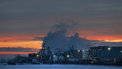In this Jan. 11, 2016 file photo, dawn approaches over the meat processing plant owned and run by Cargill Meat Solutions, in Fort Morgan, a small town on the eastern plains of Colorado. The U.S. Equal Employment Commission said Friday, Sept. 14, 2018 that Cargill has agreed to pay $1.5 million to 138 Somali-American Muslim workers who were fired from the plant in 2016 after they were refused prayer breaks.