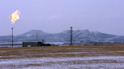 In this Feb. 25, 2015, file photo, a gas flare is seen at a natural gas processing facility near Williston, N.D. The Interior Department on Tuesday, Sept. 18, 2018, finalized the roll back of an Obama-era regulation aimed at restricting harmful methane emissions from oil and gas production on federal lands.