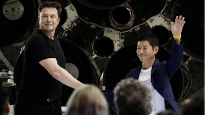 SpaceX founder and chief executive Elon Musk, left, shakes hands with Japanese billionaire Yusaku Maezawa, right, after announcing him as the first private passenger on a trip around the moon, Monday, Sept. 17, 2018, in Hawthorne, Calif.