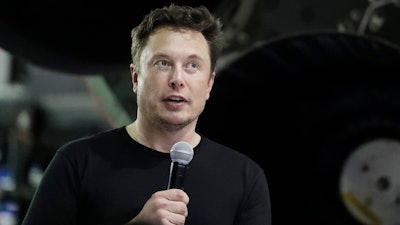 In this Monday, Sept. 17, 2018, file photo Tesla CEO and SpaceX founder and chief executive Elon Musk speaks after announcing Japanese billionaire Yusaku Maezawa as the first private passenger on a trip around the moon in Hawthorne, Calif. Tesla Inc. has turned over documents to the U.S. Justice Department after statements by Musk about taking the company private, the electric car maker confirmed Tuesday, Sept. 18.